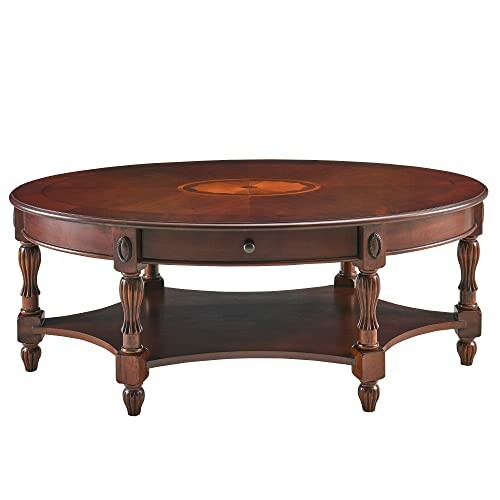 Oval wooden coffee table with decorative legs and lower shelf