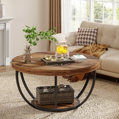 Rustic round coffee table with decorative items in a cozy living room.