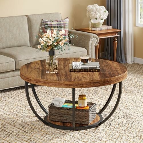 Rustic round coffee table with flowers and books in a cozy living room.