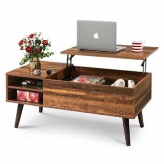 Wooden coffee table with storage, laptop, and flowers.